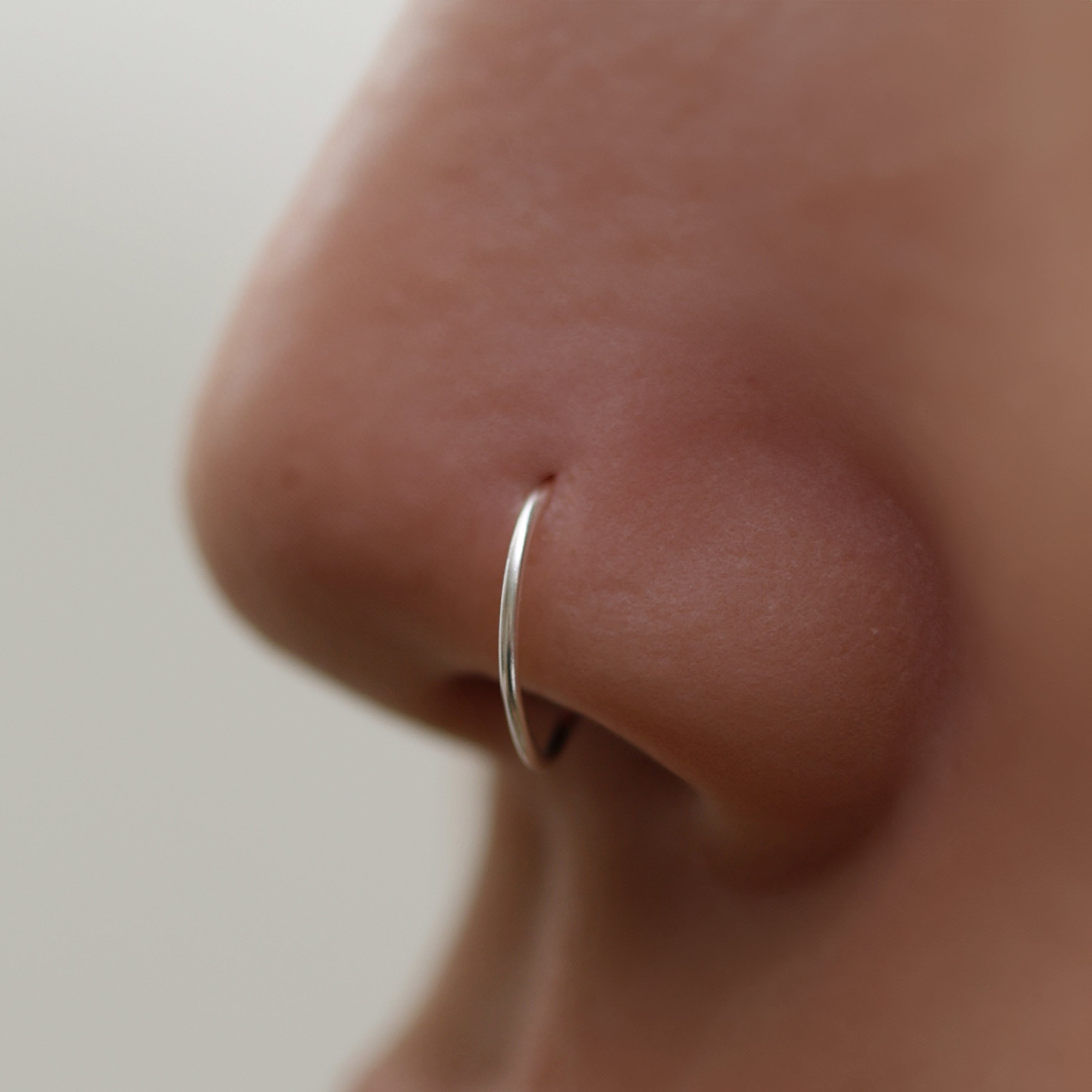 Tiny Nose Hoop featuring a sleek, minimalist design for subtle everyday elegance, offering a secure and comfortable fit for effortless, dainty style.