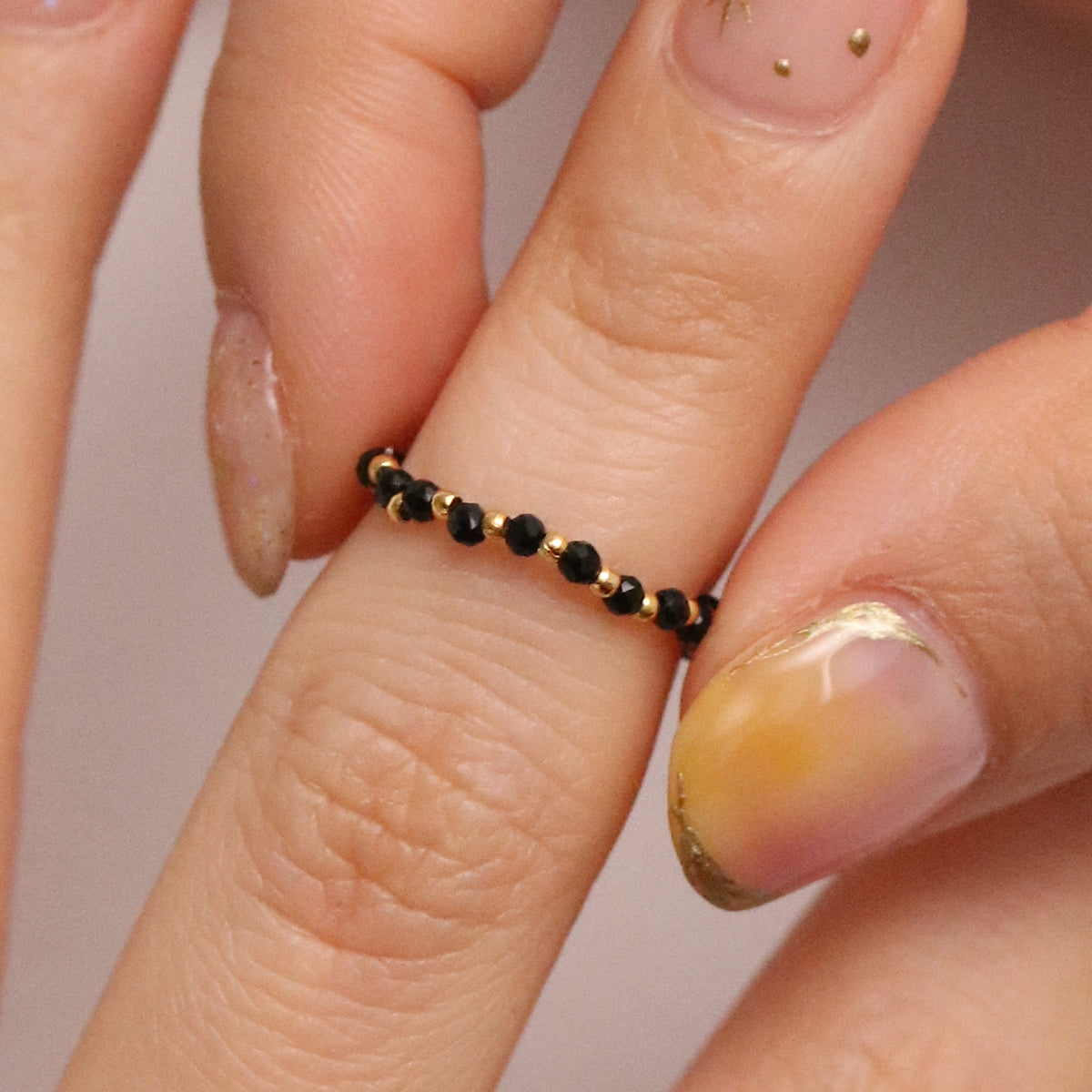 Stretchy Gemstone Ring featuring semi-precious gemstones and delicate sterling silver plated beads, offering a comfortable fit with a touch of refined elegance.