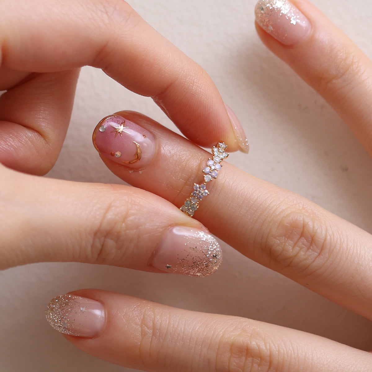 Moonstone Flower Ring featuring a radiant moonstone centre and delicate floral design, crafted from high-quality materials for a touch of timeless elegance.