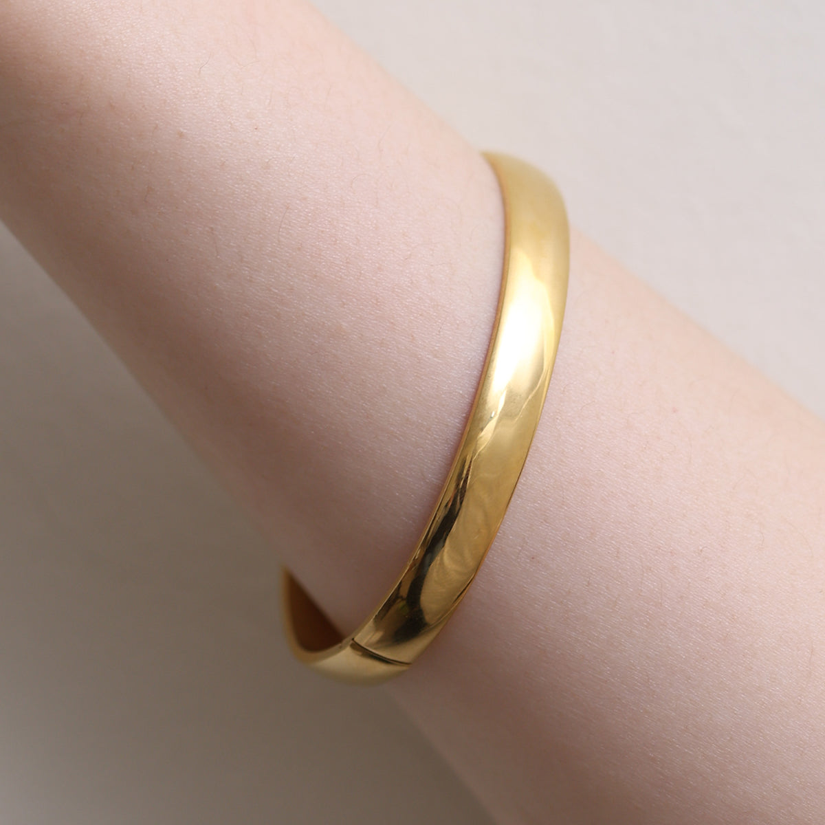 Thick Minimalist Bangle featuring clean lines and a robust profile, expertly crafted for durability and elegance—perfect for elevating both casual and formal looks.