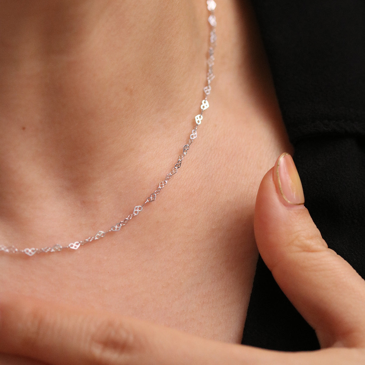 Charming Relay hearts necklace with interconnected heart-shaped links, featuring a delicate design and polished finish.