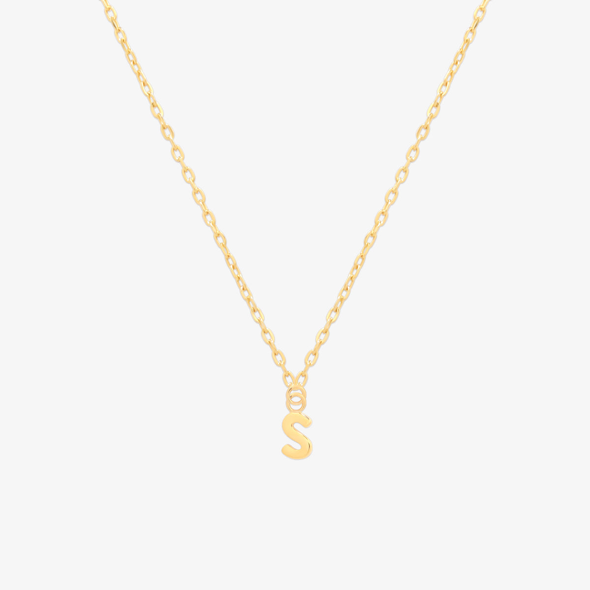 Classic initial pendant necklace featuring a polished letter charm on a delicate chain, showcasing a timeless and elegant design.