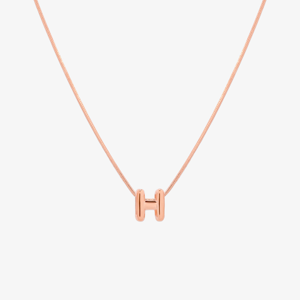 Bubble initial pendant necklace featuring a rounded, playful letter charm on a sleek snake chain, with a smooth and glossy finish.