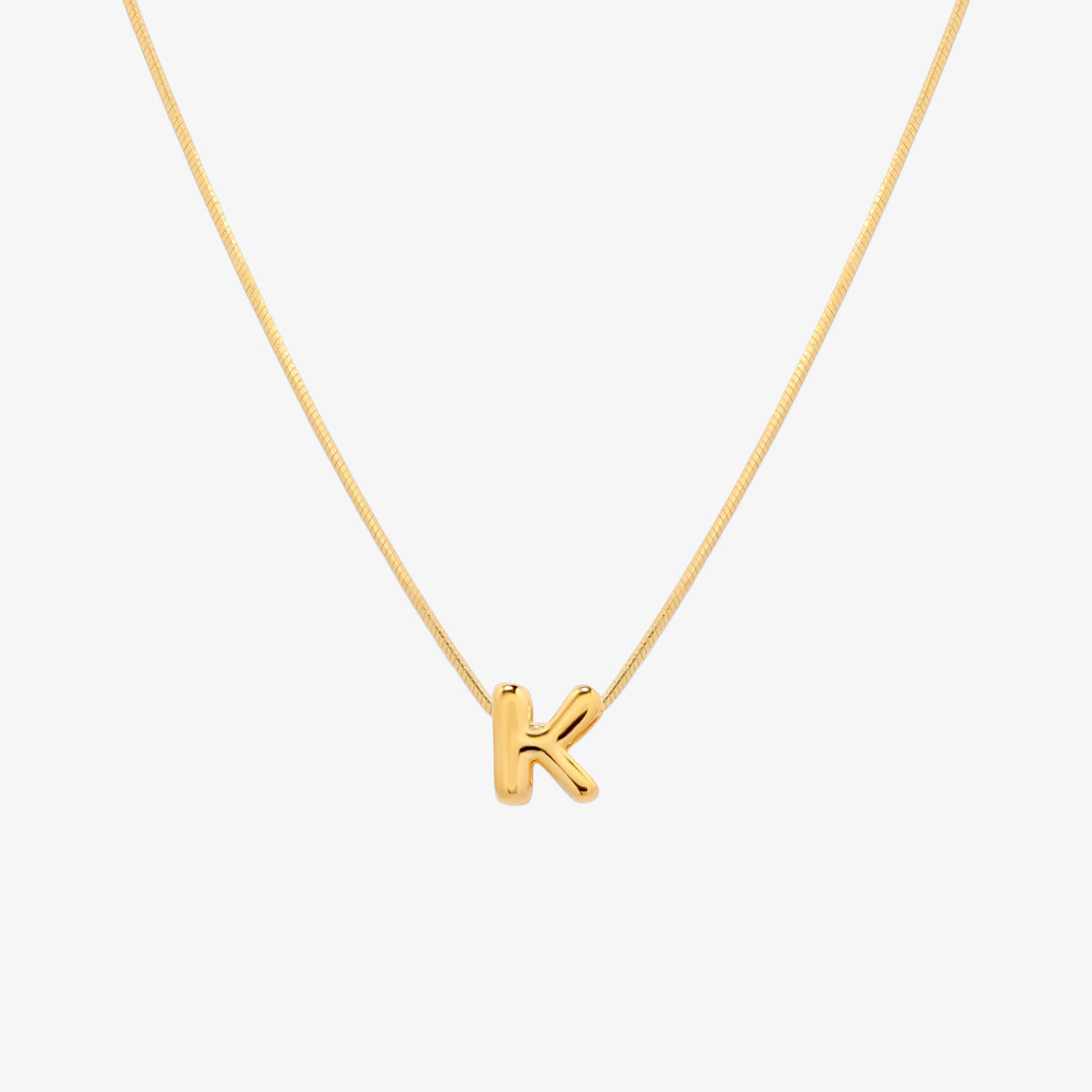Bubble initial pendant necklace featuring a rounded, playful letter charm on a sleek snake chain, with a smooth and glossy finish.