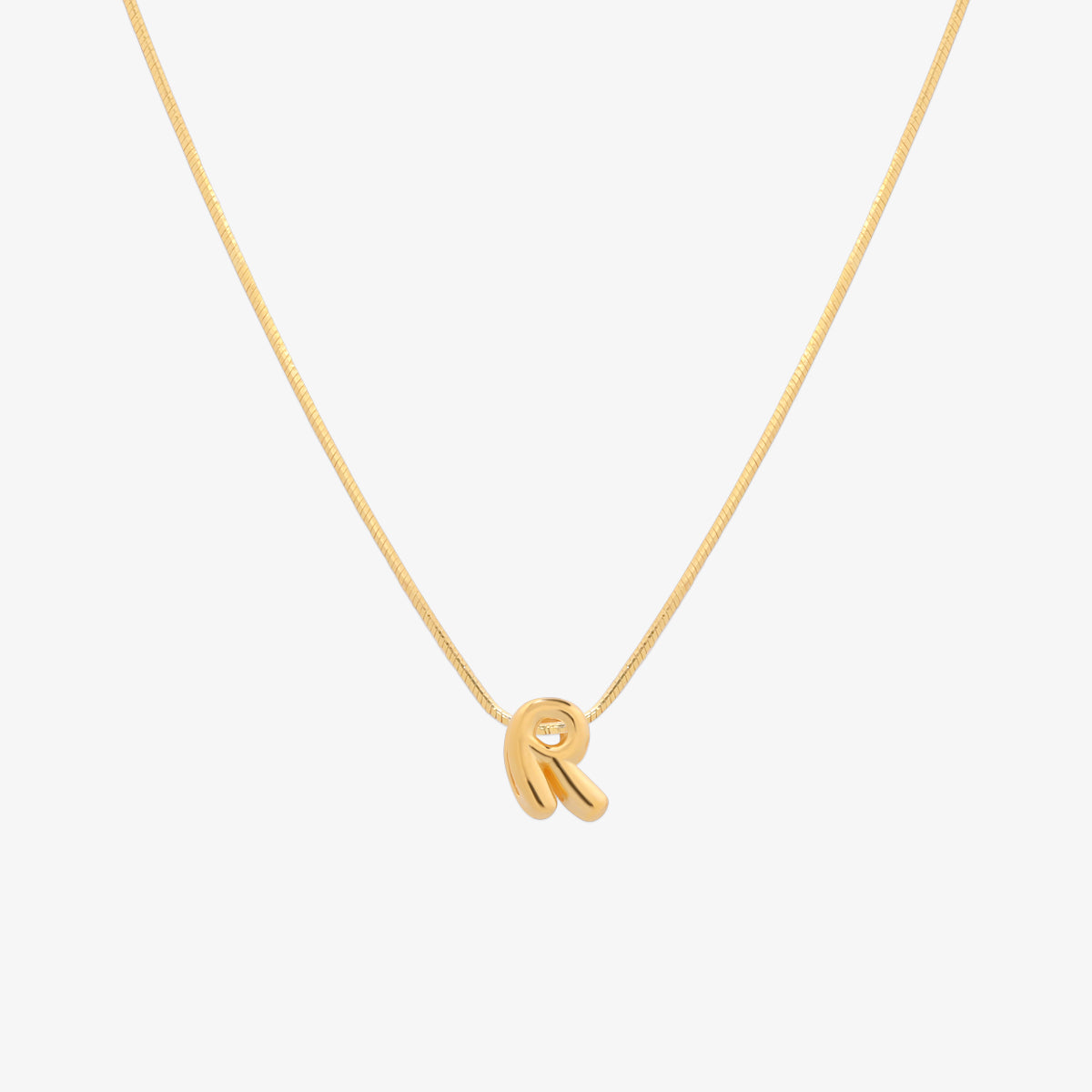 Bubble initial pendant necklace featuring a rounded, playful letter charm on a sleek snake chain, with a smooth and glossy finish.
