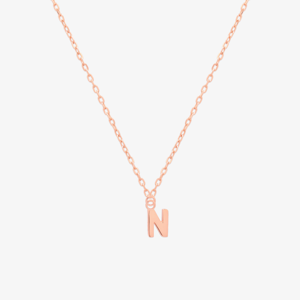 Classic initial pendant necklace featuring a polished letter charm on a delicate chain, showcasing a timeless and elegant design.