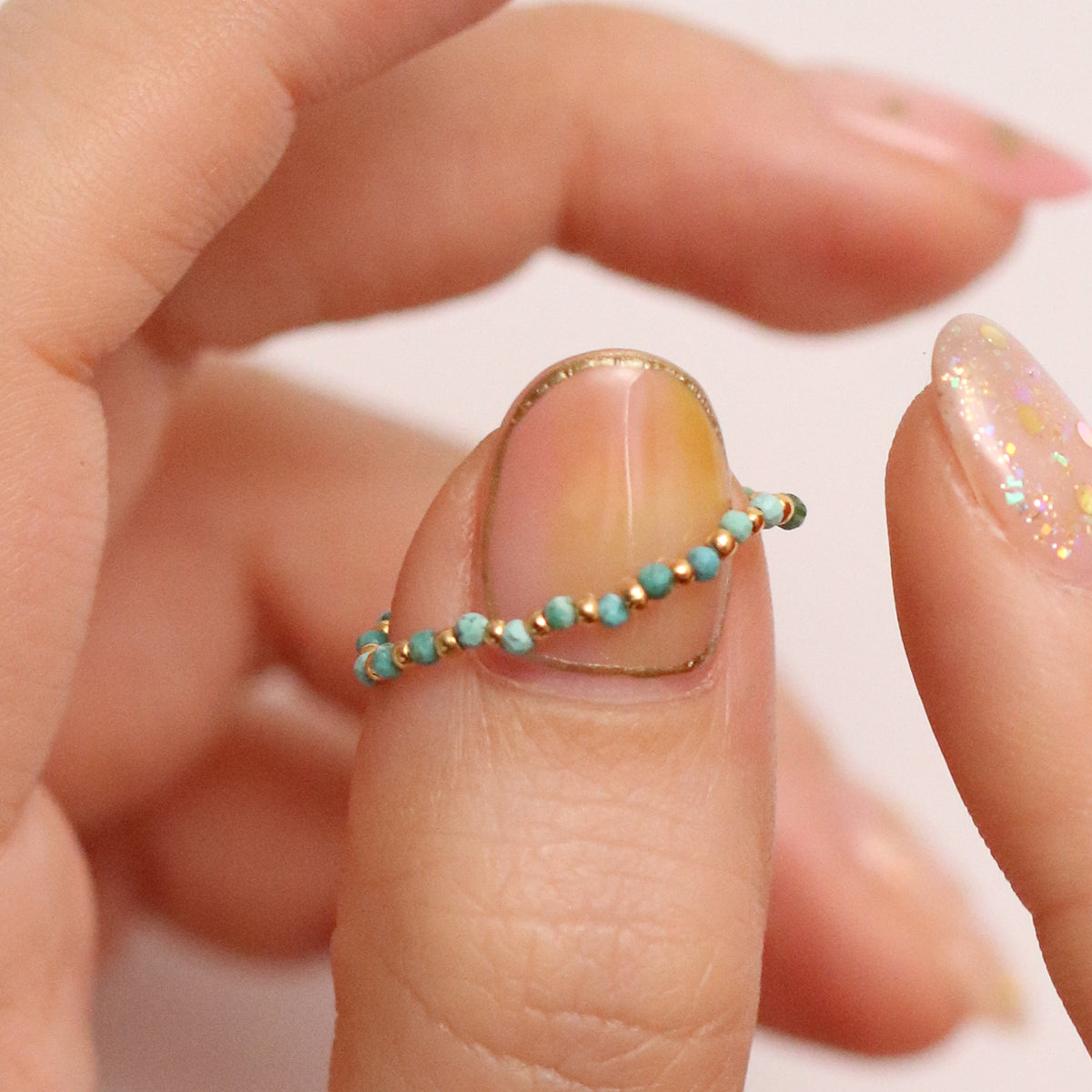 Stretchy Gemstone Ring featuring semi-precious gemstones and delicate sterling silver plated beads, offering a comfortable fit with a touch of refined elegance.