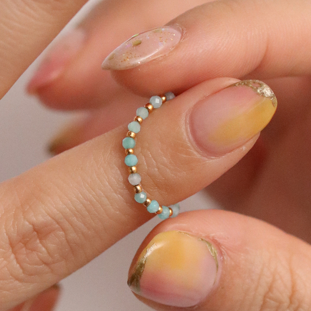 Stretchy Gemstone Ring featuring semi-precious gemstones and delicate sterling silver plated beads, offering a comfortable fit with a touch of refined elegance.