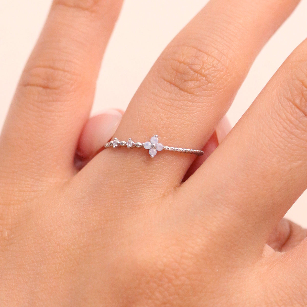 Moonstone Cubic Flower Ring handcrafted with a glowing moonstone centre and delicate cubic flower petals, blending natural beauty.