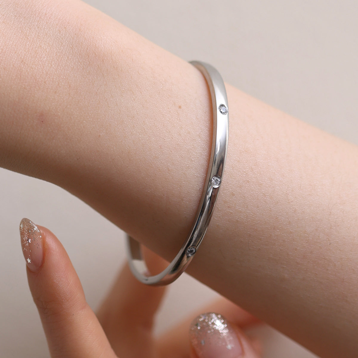 Thin Cubic Bangle precision-crafted with cubic design elements, offering a minimalist aesthetic, lightweight comfort, and versatile elegance for standalone wear or stylish layering.