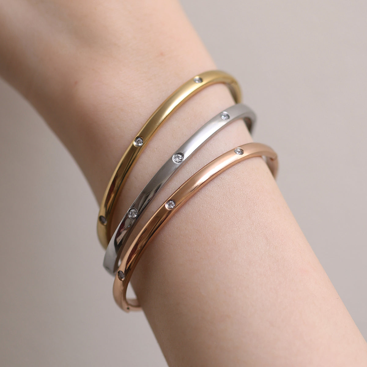 Thin Cubic Bangle precision-crafted with cubic design elements, offering a minimalist aesthetic, lightweight comfort, and versatile elegance for standalone wear or stylish layering.