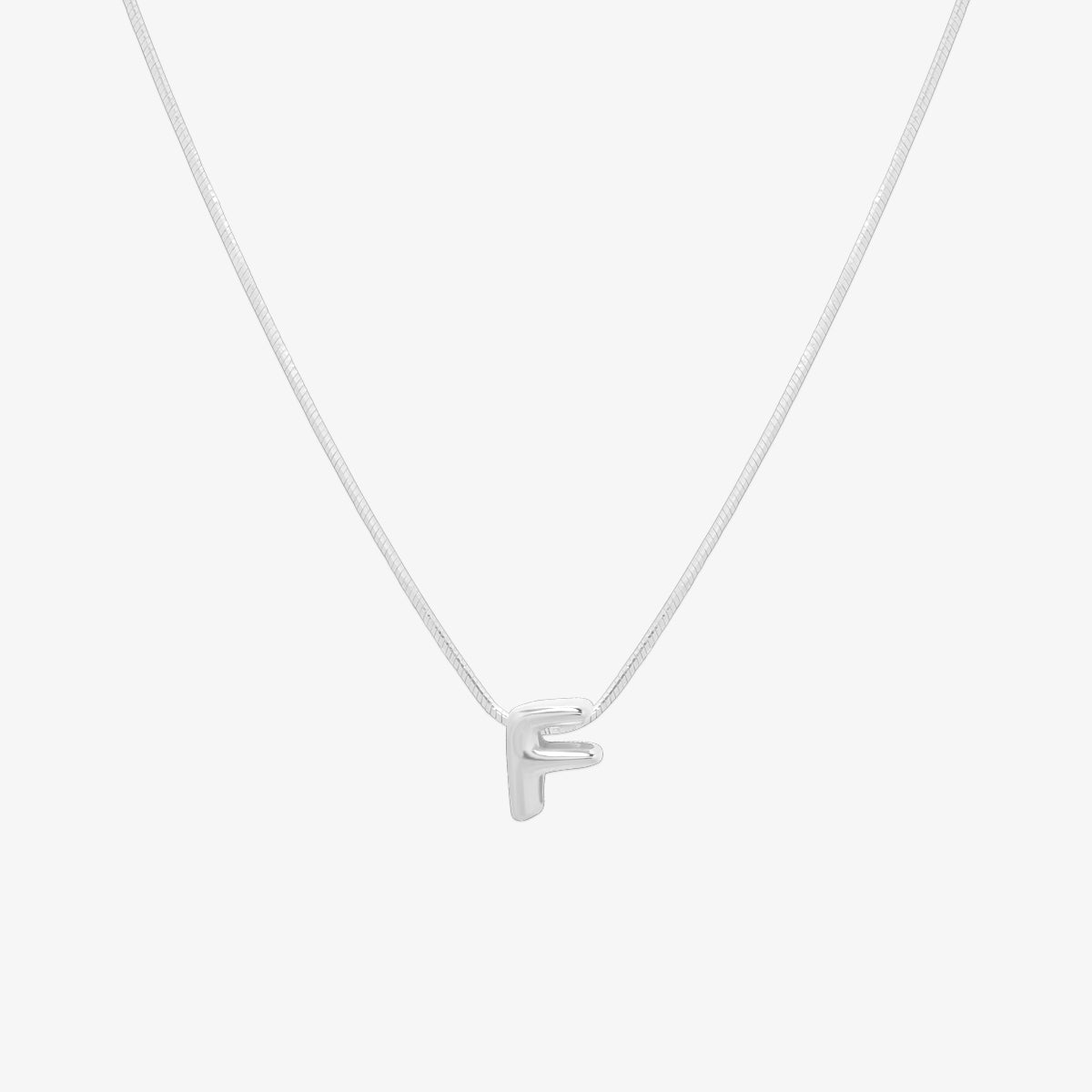 Bubble initial pendant necklace featuring a rounded, playful letter charm on a sleek snake chain, with a smooth and glossy finish.