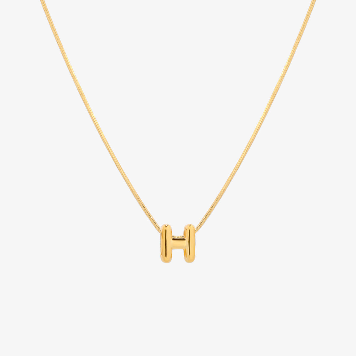 Bubble initial pendant necklace featuring a rounded, playful letter charm on a sleek snake chain, with a smooth and glossy finish.