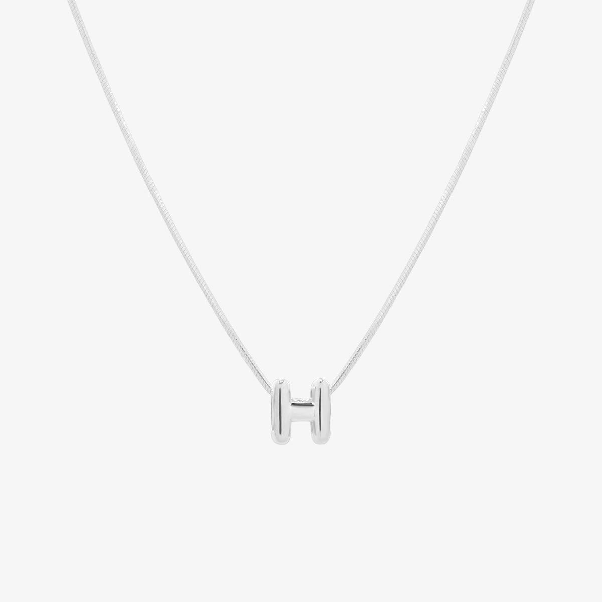 Bubble initial pendant necklace featuring a rounded, playful letter charm on a sleek snake chain, with a smooth and glossy finish.