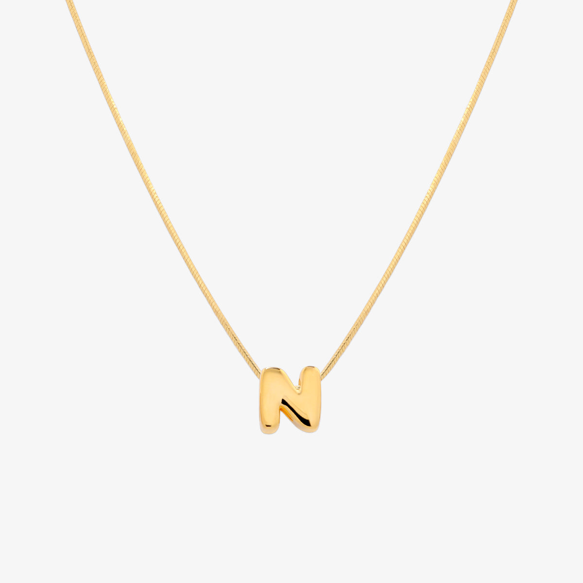 Bubble initial pendant necklace featuring a rounded, playful letter charm on a sleek snake chain, with a smooth and glossy finish.