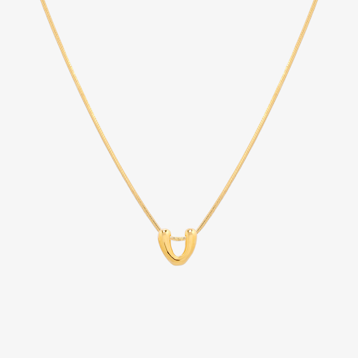 Bubble initial pendant necklace featuring a rounded, playful letter charm on a sleek snake chain, with a smooth and glossy finish.