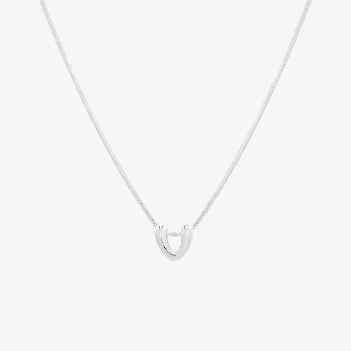 Bubble initial pendant necklace featuring a rounded, playful letter charm on a sleek snake chain, with a smooth and glossy finish.