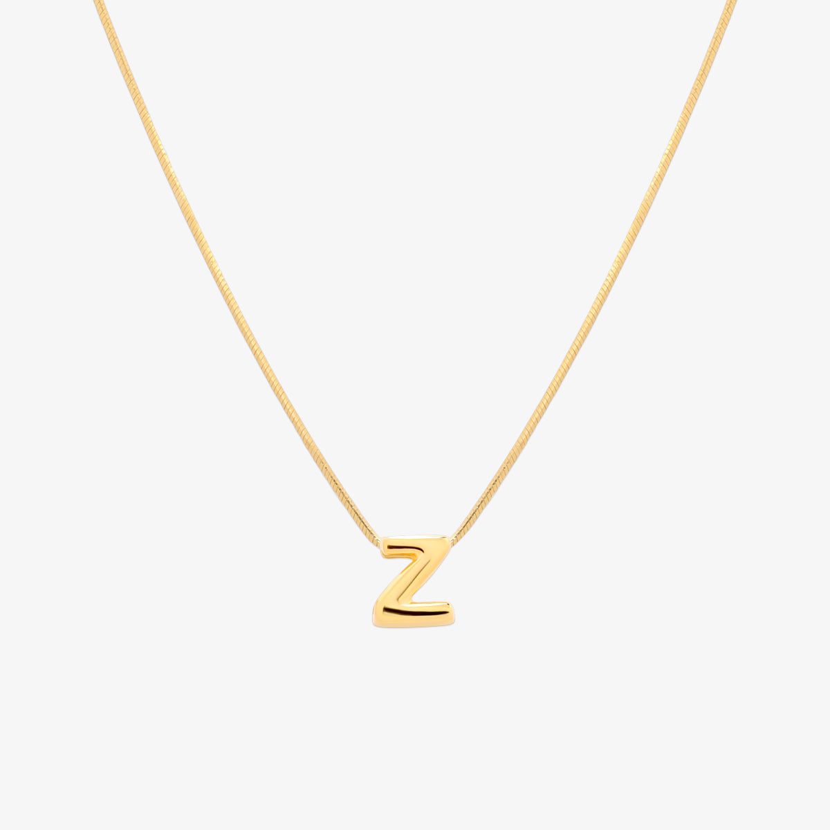 Bubble initial pendant necklace featuring a rounded, playful letter charm on a sleek snake chain, with a smooth and glossy finish.