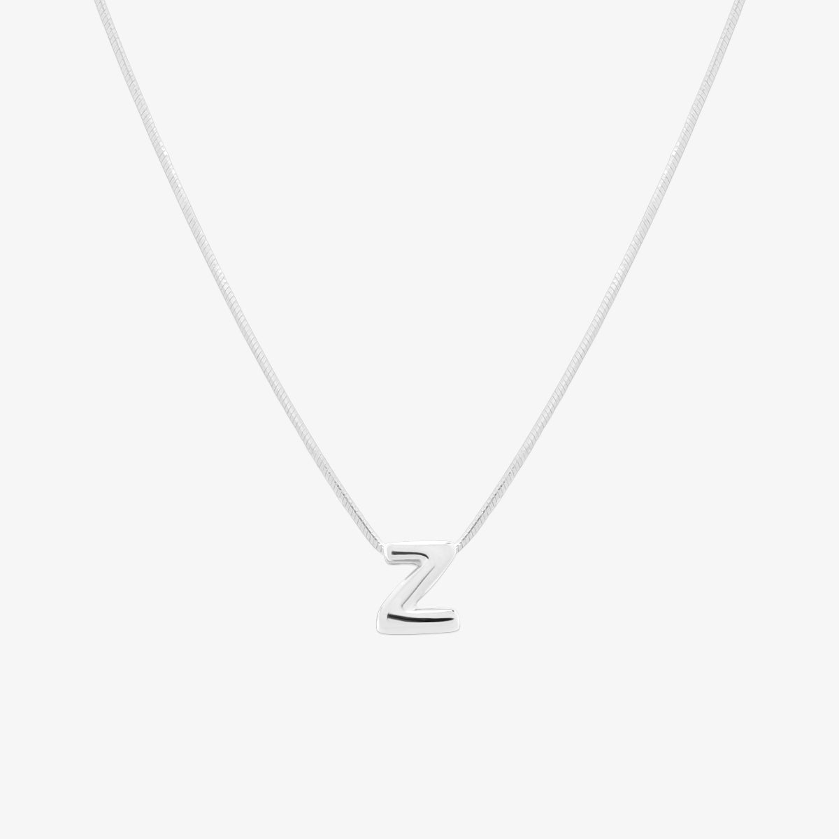 Bubble initial pendant necklace featuring a rounded, playful letter charm on a sleek snake chain, with a smooth and glossy finish.
